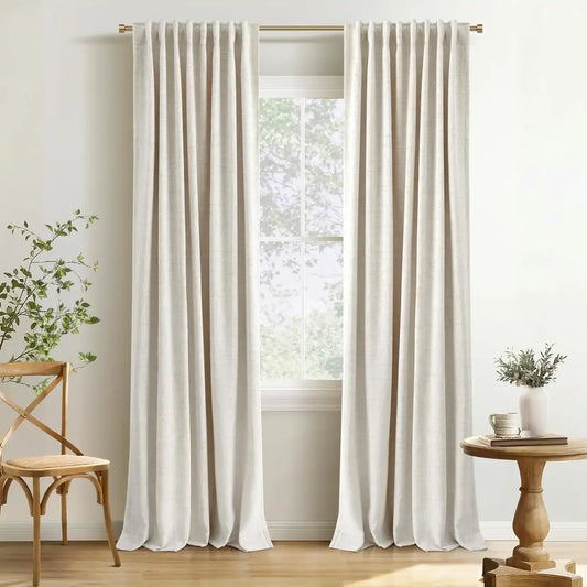 Cream Akina linen blackout curtains on a black rod in a living room