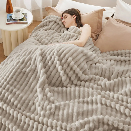 The Natural Akina corduroy blanket spread across a bed