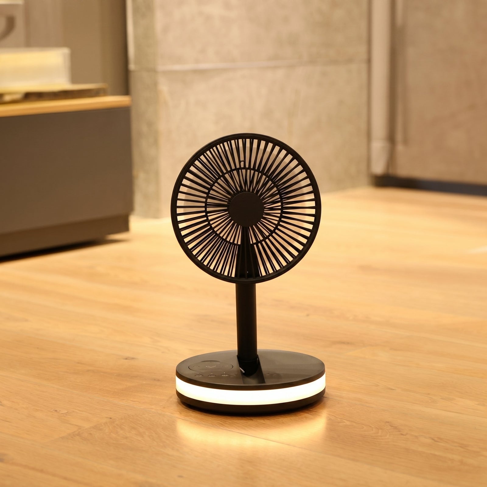Akina Portable Fan running on a bedroom floor at night, base light casting a soft warm glow on the wood floor